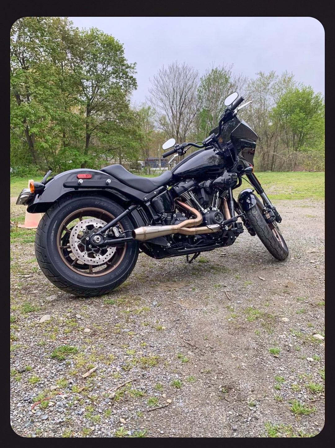 Stealth Pipes exhaust system installed on Harley M8 Softail – rear-side view of muffler and headers (2017–2025)